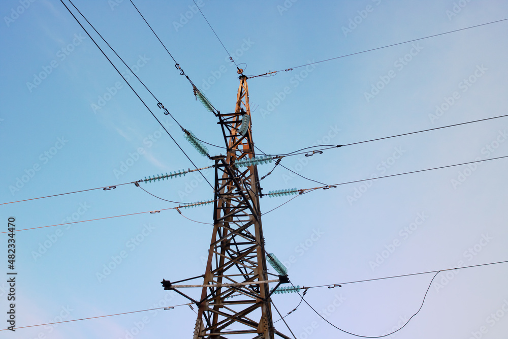 Pillar with electric wires against the blue sky Pillar with electric wires against the blue sky