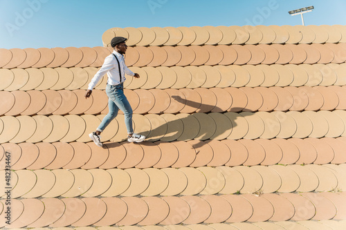 Young man walking on roofing tiles
