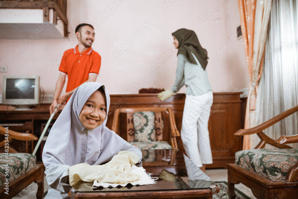 veiled girl smiling while wiping the table veiled girl smiling while wiping the table