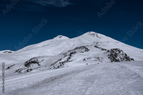 Amazing snowy mountain landscape of the Caucasus, peaks of mount Elbrus on a clear blue sky day
