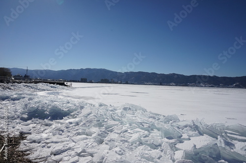 御神渡りが期待される凍った諏訪湖と湖岸に漂着した氷のブロック