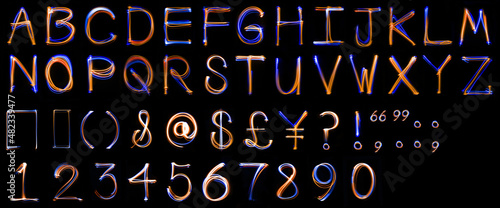 Long exposure, light drawn, uppercase alphabet.