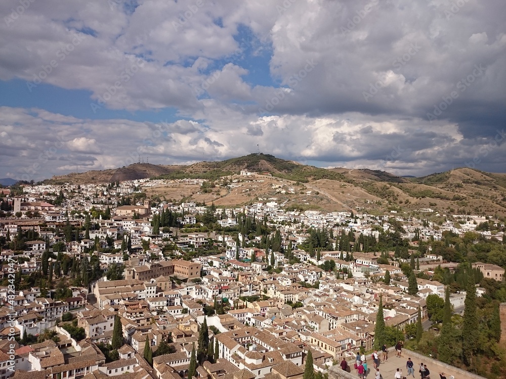 Top view of Granada, sightseeing from alcazaba, ancient city of Spain. White houses with tiled roofs in a hot climate. Mobile photography, travel route