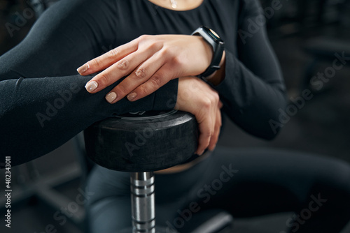 Caucasian female athlete leaning on hand weight