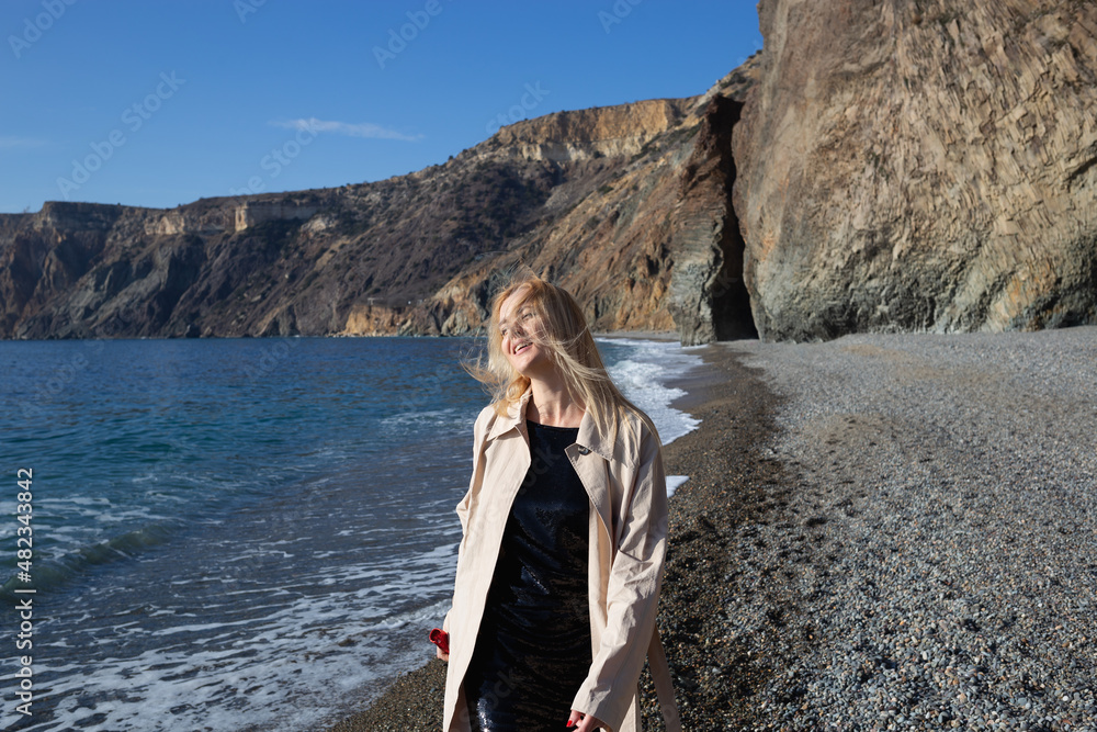young beautiful woman dancing with a bottle of champagne on the beach young beautiful woman dancing with a bottle of champagne on the beach