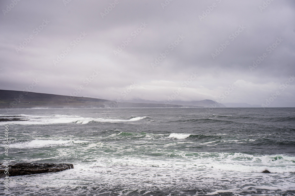 image of Atlantic ocean sea waves splashing with white foam against rocks, beach, rocky cliff, Ballycastle,mayo,ireland. Sea patterns, background wallpaper. Wild Atlantic Way Landscape