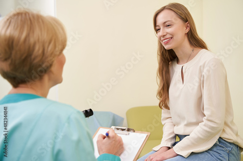 Positive female patient listening to her practitioner