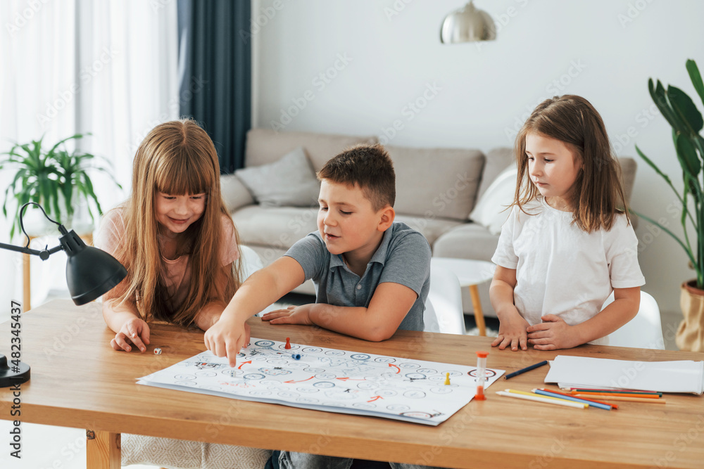 Fototapeta premium Step by step game. Kids having fun in the domestic room at daytime together