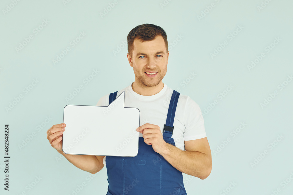 Worker saying something. Man standing in the studio with empty signs for the text Worker saying something. Man standing in the studio with empty signs for the text