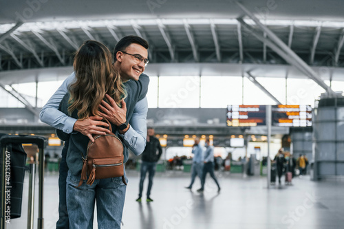 Happy young couple is in the airport together