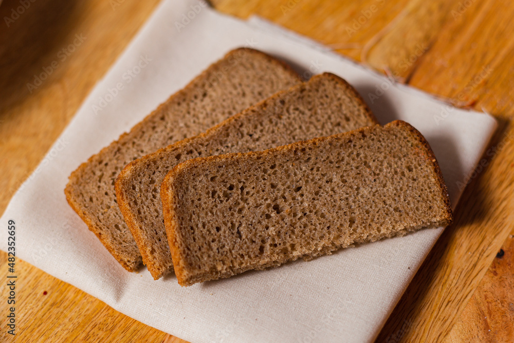 pieces of rye bread on a wooden background pieces of rye bread on a wooden background
