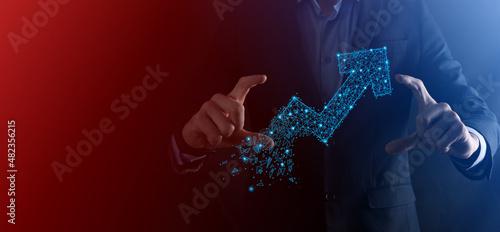 Businessman hold graph, arrow of positive growth icon.pointing at creative business chart with upward arrows.Financial, business growth concept.Low polygonal.increased sales, or increased value