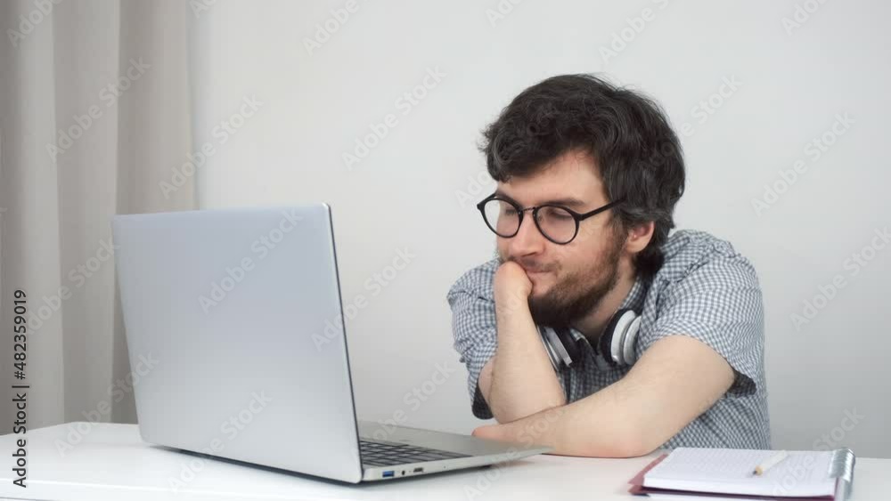 Disabled man in glasses with amputated two stump hands studying on laptop at home, distance education. Problem of adaptation to life people with disabilities. Independent Invalid person.