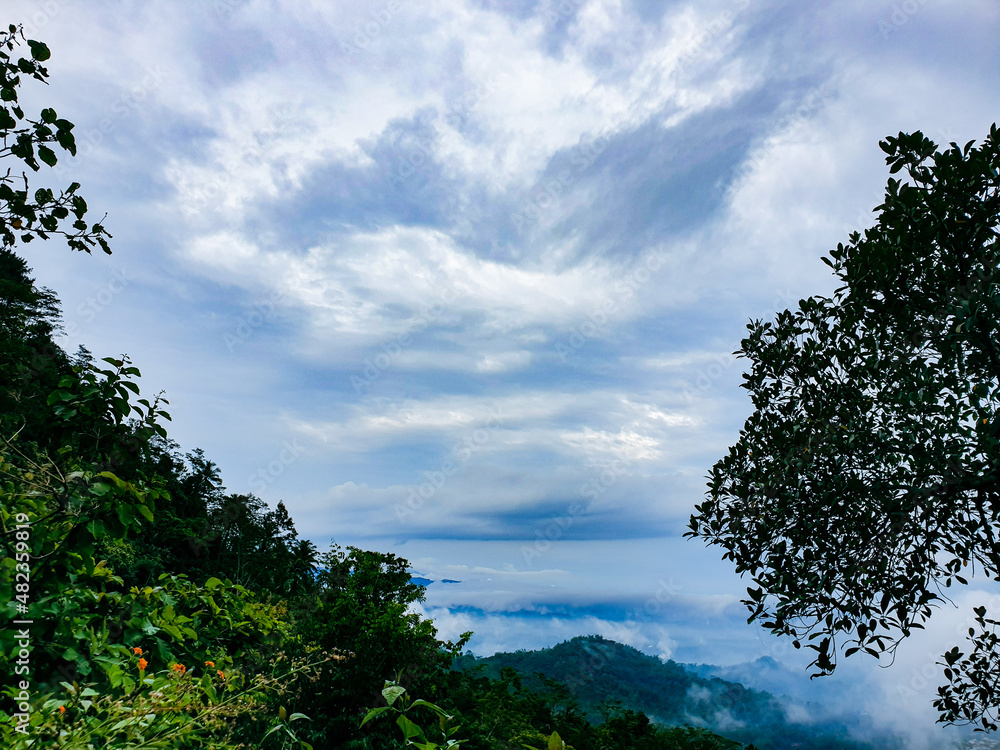 Blue sky and cloud on the village. Pastel style sky and clouds.Freshness of the new day. Trees and hill right blue background. Blue sky and cloud on the village. Pastel style sky and clouds.Freshness of the new day. Trees and hill right blue background.