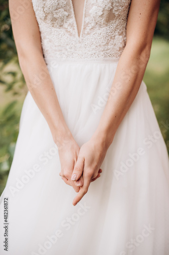 gentle touches of the bride's hand close-up