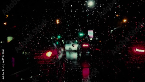 On a rainy night, cars leave the parking lot. Beautiful blure.