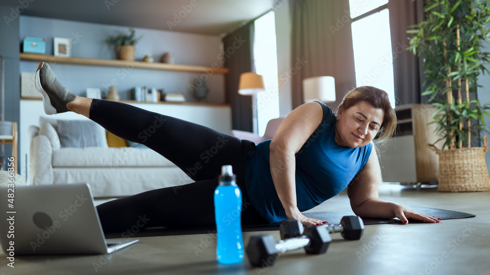 Fototapeta premium Doing sport exercises at home