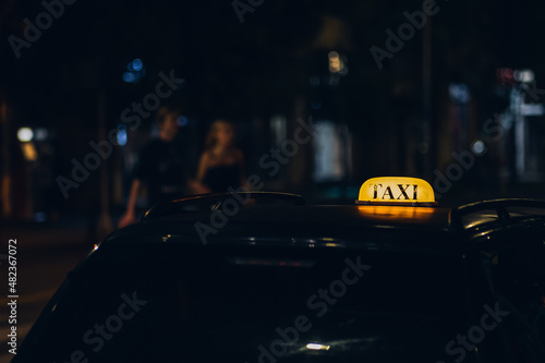 Glowing taxi sign at night in the city close-up