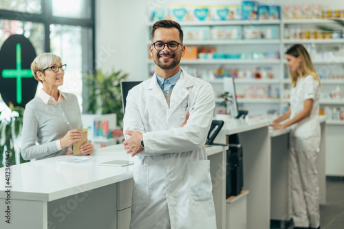 Young female pharmacist posing while working in a pharmacy