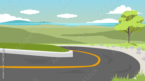 Curved asphalt road that cuts up the mountain. Landscape view of the mountains and the sea in the distance.