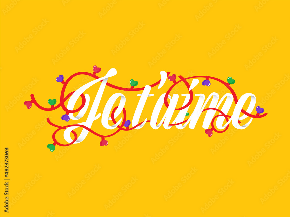 Je t'aime (I Love You) Written In French Language With Heart Lighting Garland On Yellow Background. Je t'aime (I Love You) Written In French Language With Heart Lighting Garland On Yellow Background.