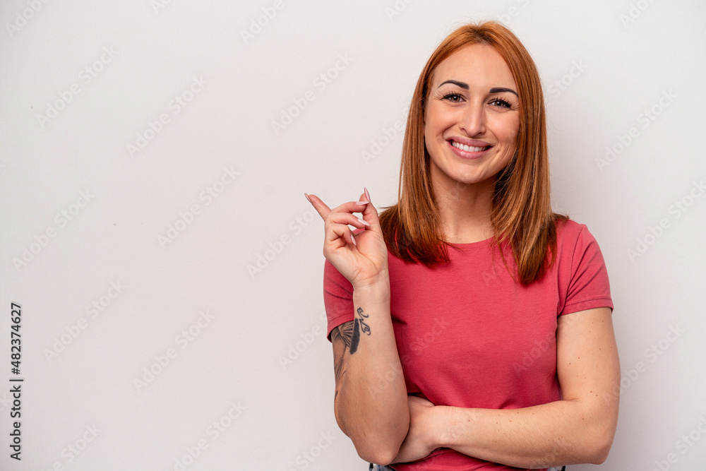 Young caucasian woman isolated on white background smiling cheerfully pointing with forefinger away. Young caucasian woman isolated on white background smiling cheerfully pointing with forefinger away.