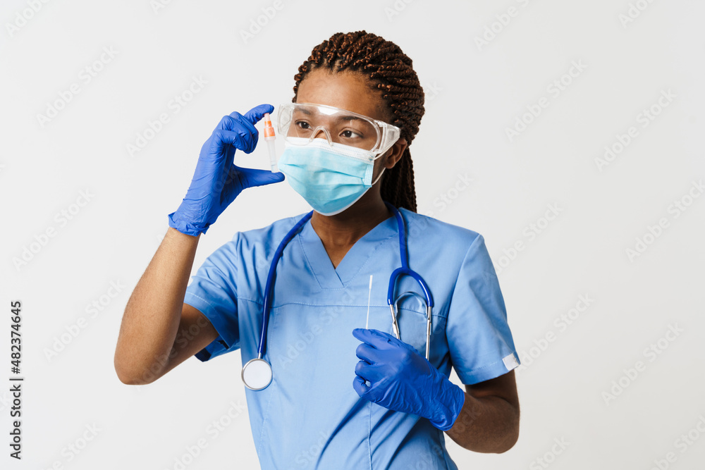 Black doctor wearing face mask posing with covid test Black doctor wearing face mask posing with covid test