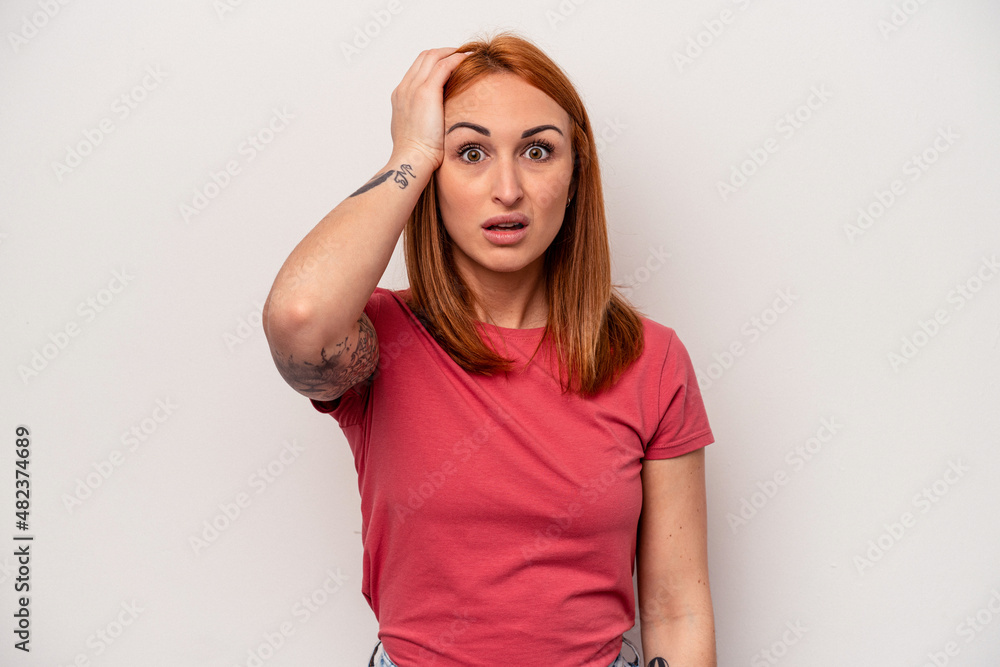 Fototapeta premium Young caucasian woman isolated on white background being shocked, she has remembered important meeting.