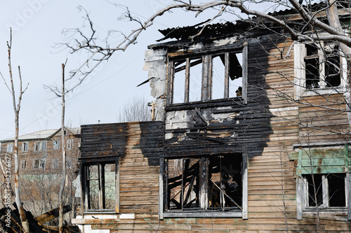 The old wooden burned-down house front view