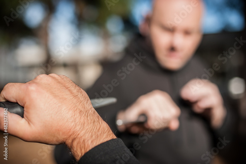 Knife vs knife fight. Kapap instructors demonstrates sombrada drill training
