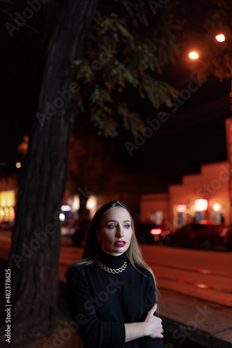 Portrait of beautiful caucasian woman with long hair on the night city street. © luengo_ua