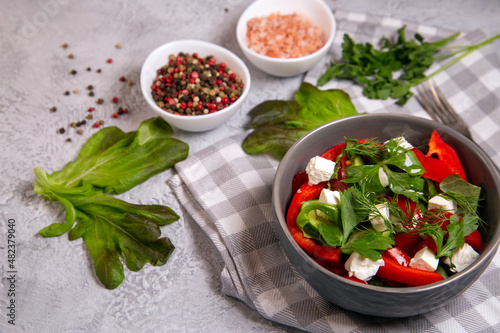 Salad of fresh vegetables with herbs and feta cheese. Healthy food rich in vitamins, fiber, antioxidants.