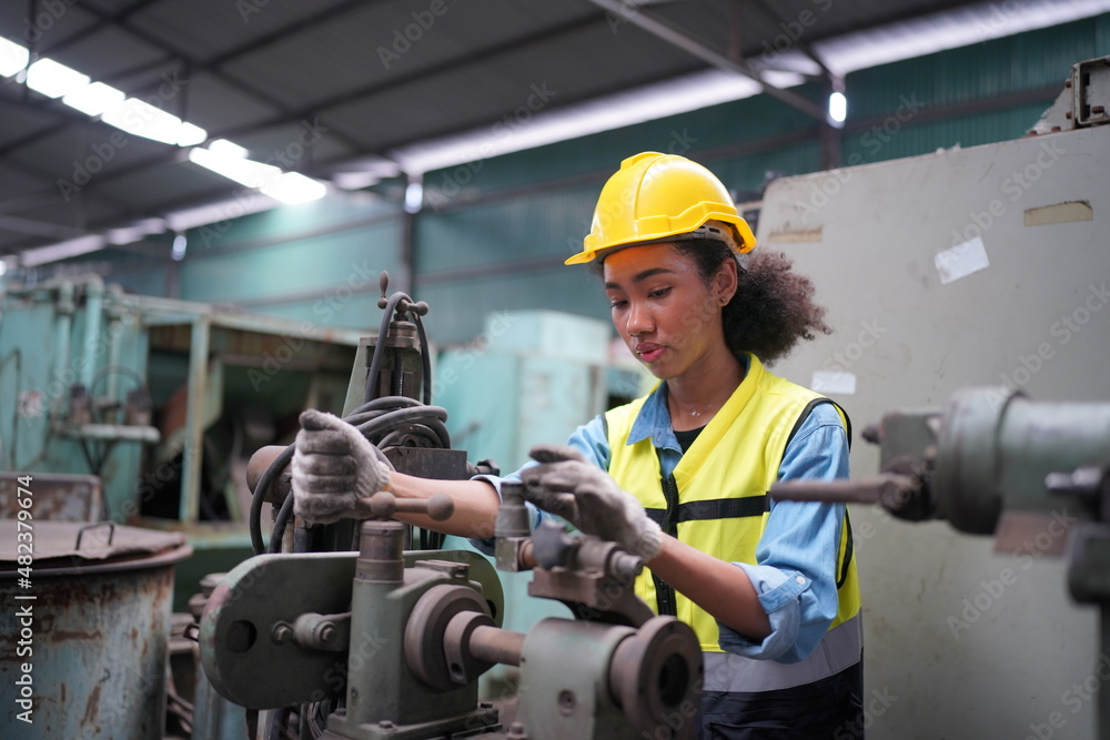 Female apprentice in metal working factory, Portrait of working female industry technical worker or engineer woman working in an industrial manufacturing factory company. Female apprentice in metal working factory, Portrait of working female industry technical worker or engineer woman working in an industrial manufacturing factory company.