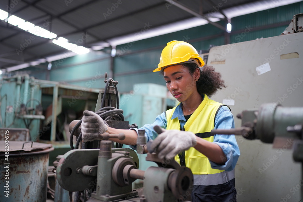 Female apprentice in metal working factory, Portrait of working female industry technical worker or engineer woman working in an industrial manufacturing factory company. Female apprentice in metal working factory, Portrait of working female industry technical worker or engineer woman working in an industrial manufacturing factory company.
