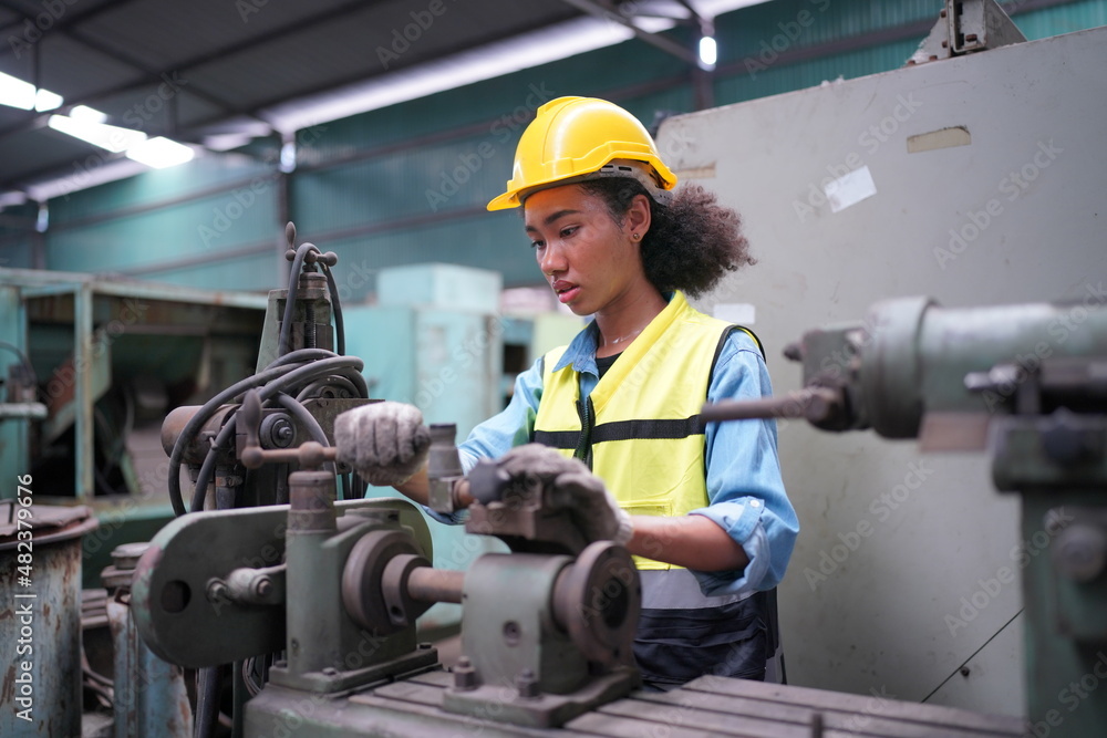 Female apprentice in metal working factory, Portrait of working female industry technical worker or engineer woman working in an industrial manufacturing factory company. Female apprentice in metal working factory, Portrait of working female industry technical worker or engineer woman working in an industrial manufacturing factory company.