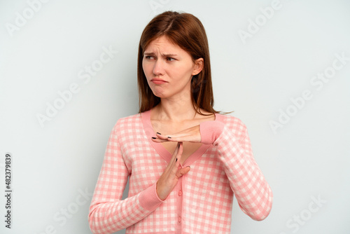 Young English woman isolated on blue background showing a timeout gesture. © Asier