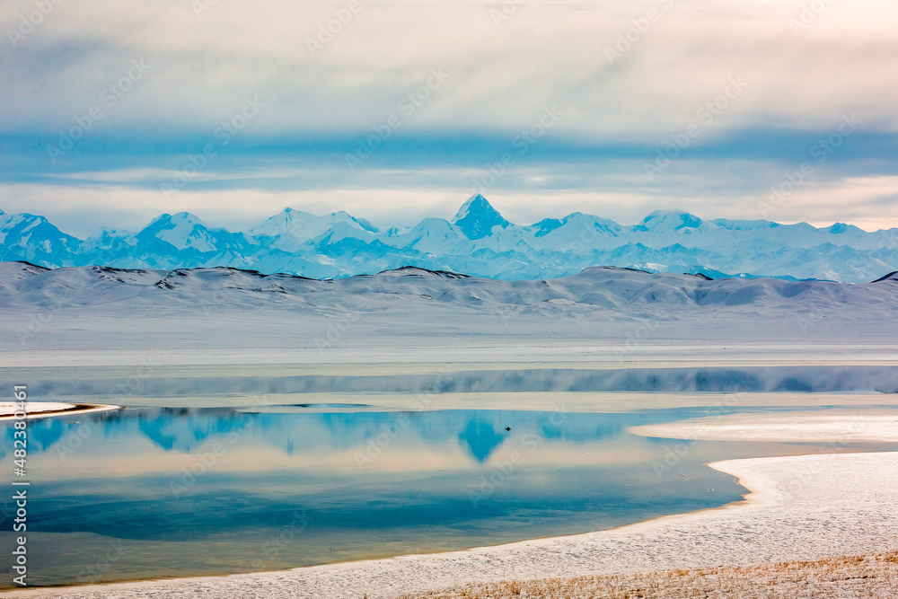 Khan Tengri Peak. Tian Shan Mountains. Tuzkol lake of Kazakhstan. Winter mountains landscape