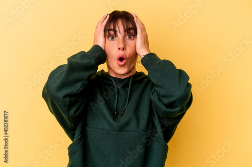 Young Argentinian woman isolated on yellow background being shocked, she has remembered important meeting. © Asier