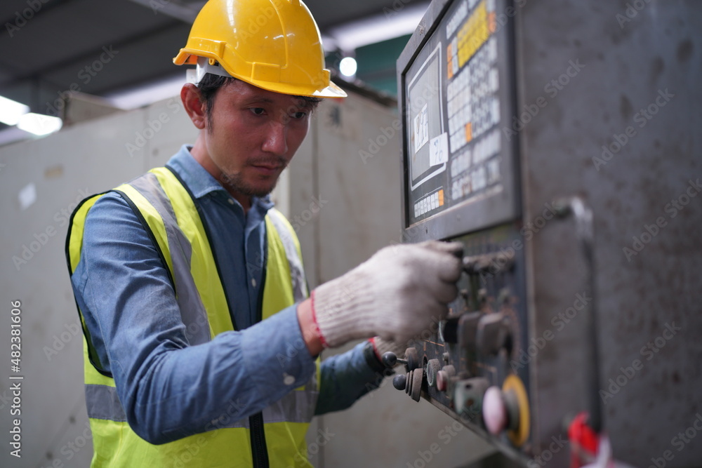 Male engineer metalworker industrial experienced operator technician worker in safety hard helmet working on lathe machine, professional man in industry technology manufacturing factory workshop Male engineer metalworker industrial experienced operator technician worker in safety hard helmet working on lathe machine, professional man in industry technology manufacturing factory workshop
