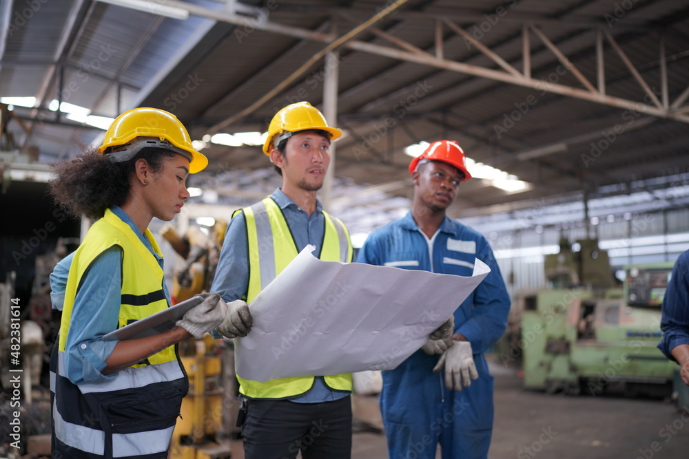 Portrait of Professional Heavy Industry Engineer / Worker Wearing Safety Uniform, Goggles and Hard Hat. In the Background Unfocused Large Industrial Factory Portrait of Professional Heavy Industry Engineer / Worker Wearing Safety Uniform, Goggles and Hard Hat. In the Background Unfocused Large Industrial Factory
