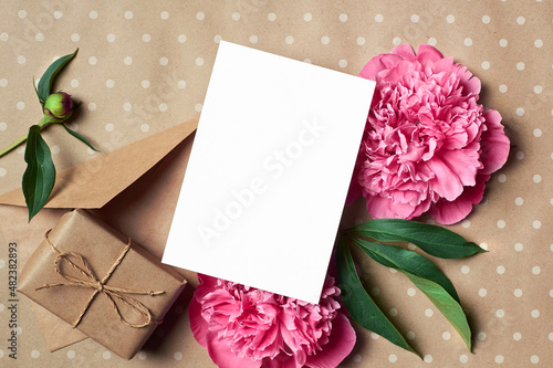 Wallpaper Mural Greeting or invitation card mockup with envelope, gift and pink peony flowers on craft paper background Torontodigital.ca