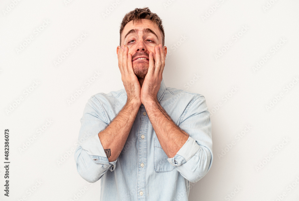 Young caucasian man isolated on white background has friendly expression, pressing palm to chest. Love concept. Young caucasian man isolated on white background has friendly expression, pressing palm to chest. Love concept.