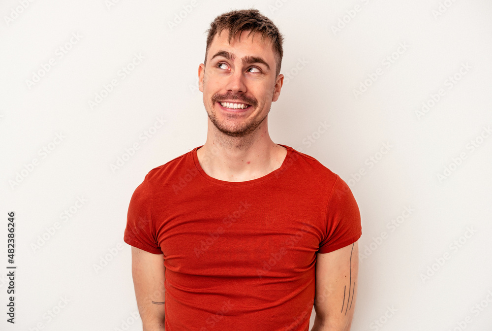 Young caucasian man isolated on white background celebrating a special day, jumps and raise arms with energy. Young caucasian man isolated on white background celebrating a special day, jumps and raise arms with energy.