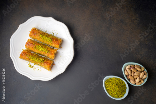 Leinwand Poster Turkish famous dessert burma kadayif on plate with pistachio