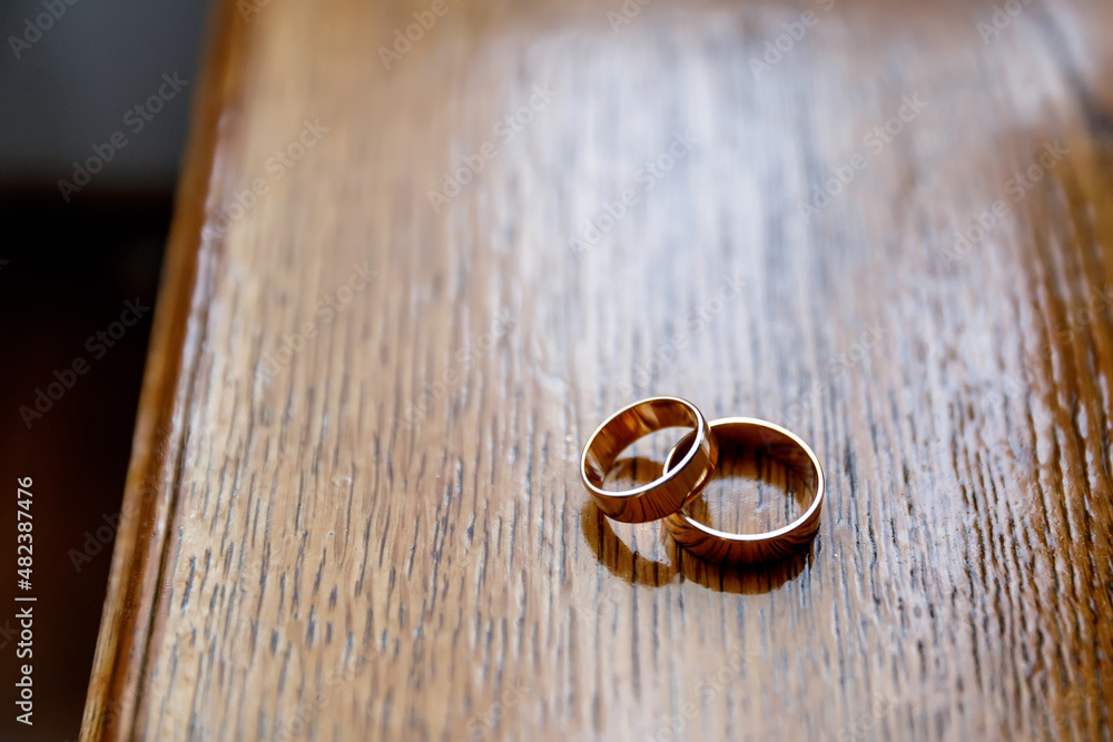 two wedding rings on background of the wooden brown table two wedding rings on background of the wooden brown table