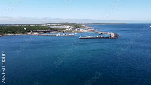 Deep blue see and small working harbor and factory of Gansbay small rolling waves and the coastline of South Africa photo