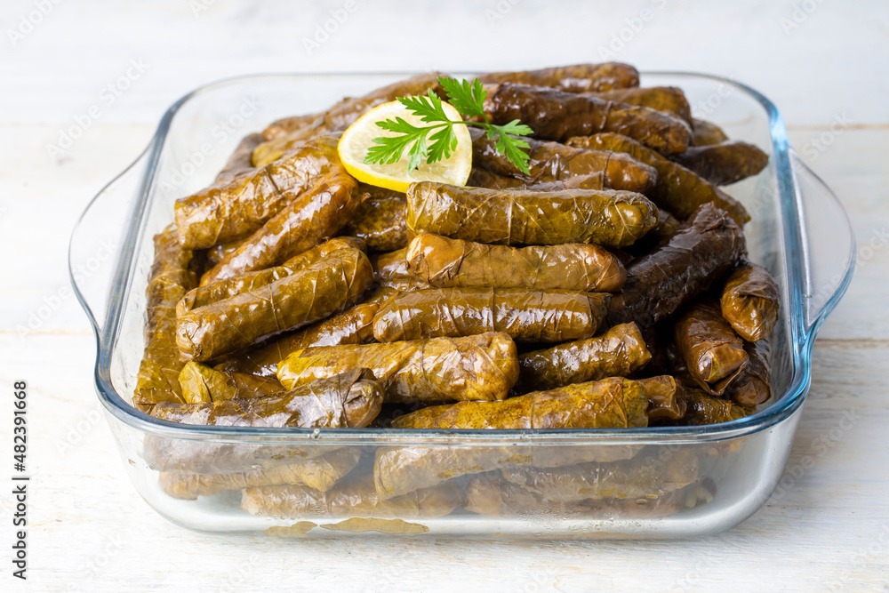 Delicious dolma (sarma) stuffed grape leaves rice,. Lebanese dolma sarma on plate. Lebanon turkish greek middle eastern cuisine. (Turkish name; Yaprak sarma) Delicious dolma (sarma) stuffed grape leaves rice,. Lebanese dolma sarma on plate. Lebanon turkish greek middle eastern cuisine. (Turkish name; Yaprak sarma)