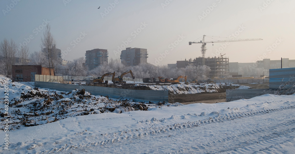Newly built large avenue. New residential area. Construction site. Buildings under construction. White snow. Ust-Kamenogorsk (kazakhstan)