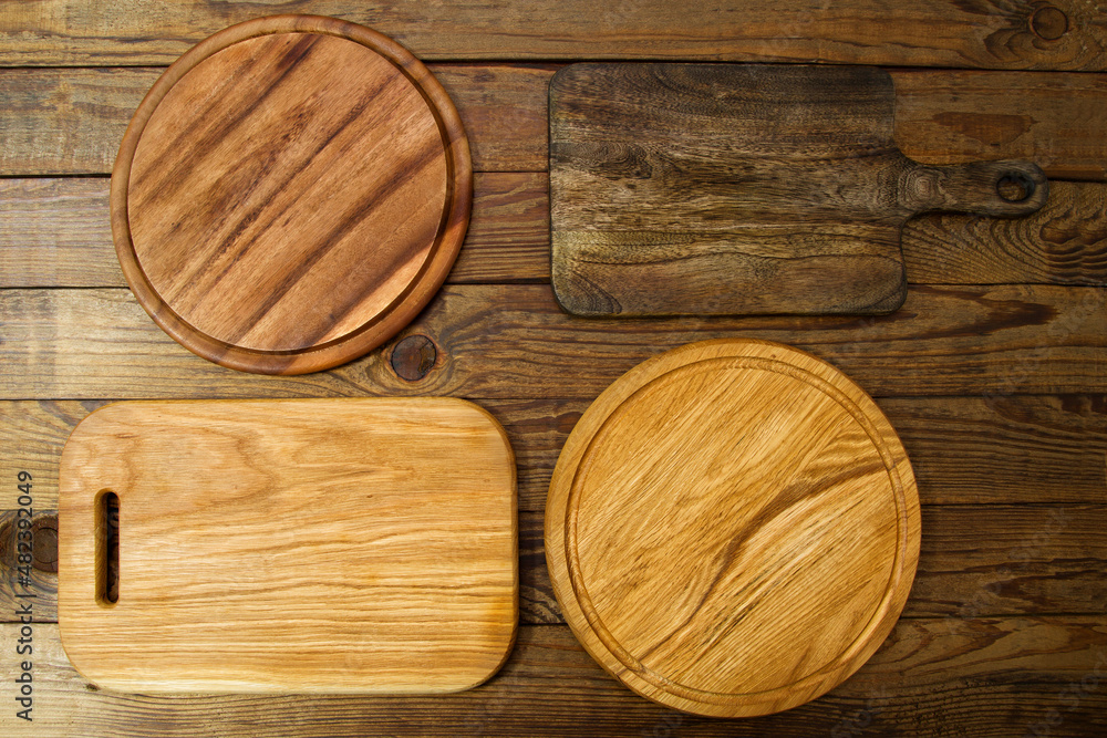 Pizza round wood cutting board mockup top view. Different types of kitchen boards on wooden background. Copy space on workspace tabletop. Thanksgiving day Pizza round wood cutting board mockup top view. Different types of kitchen boards on wooden background. Copy space on workspace tabletop. Thanksgiving day