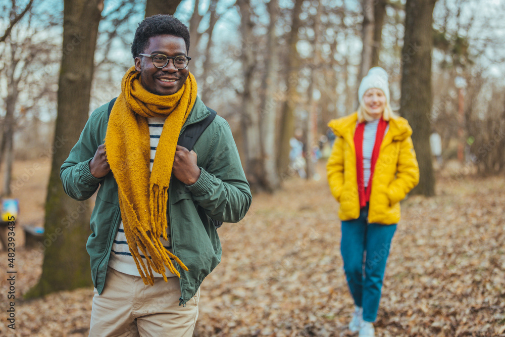 View of men and women walking on a rocky path in the woods. A couple of hikers exploring nature while walking in the woods. Happy young couple going for a romantic walk in the woods View of men and women walking on a rocky path in the woods. A couple of hikers exploring nature while walking in the woods. Happy young couple going for a romantic walk in the woods